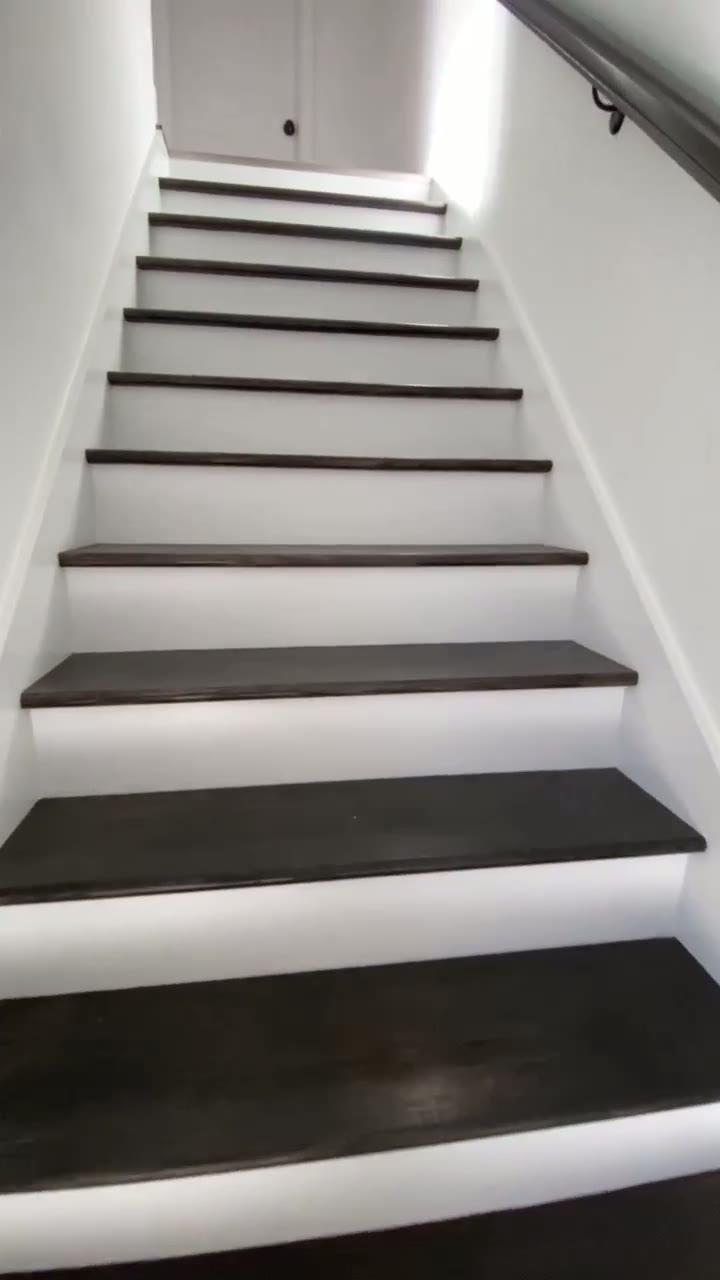 Staircase transformation from worn treads to refinished dark treads with white risers