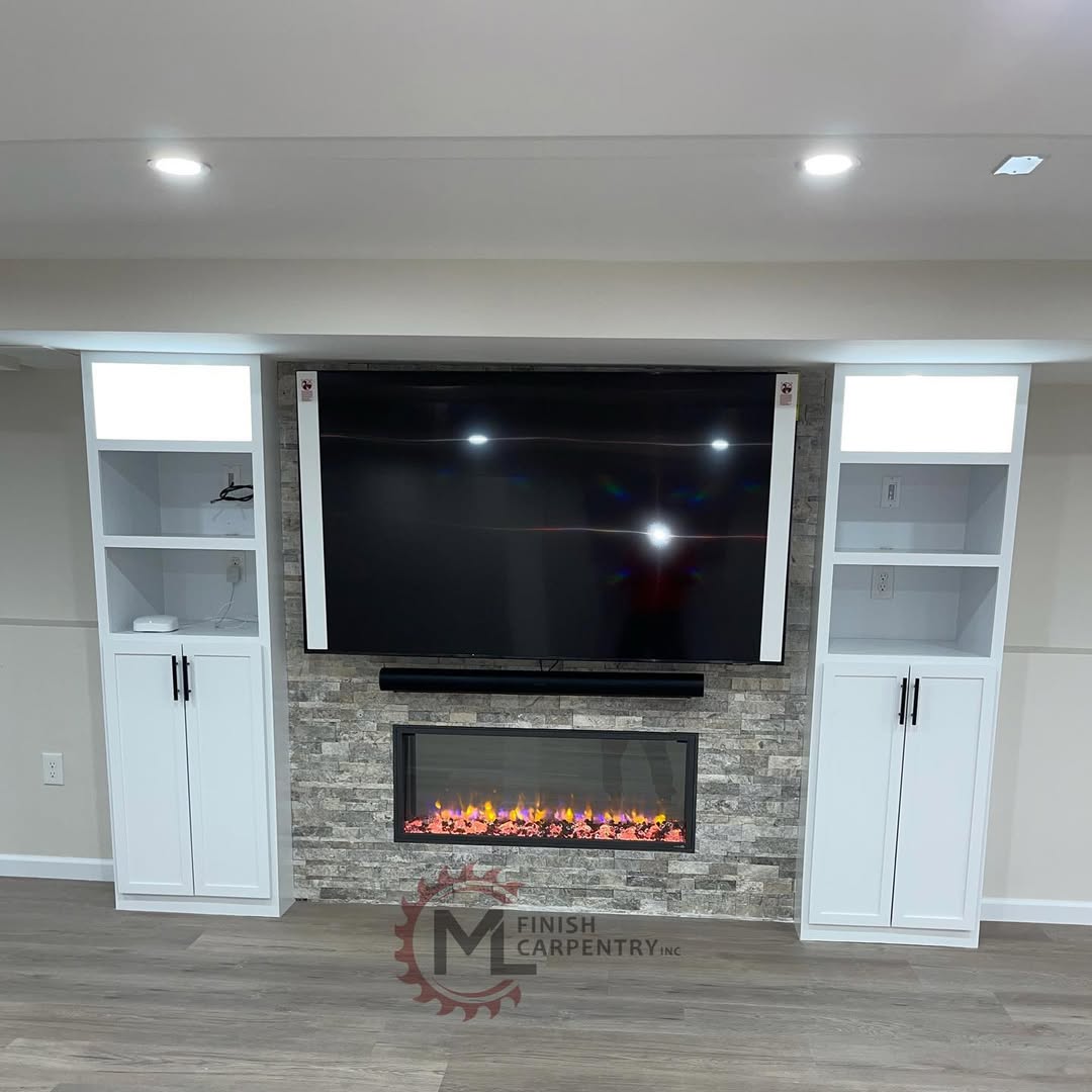 Fireplace and media built-in with stacked stone surround, linear fireplace and flanking white cabinets with open shelving