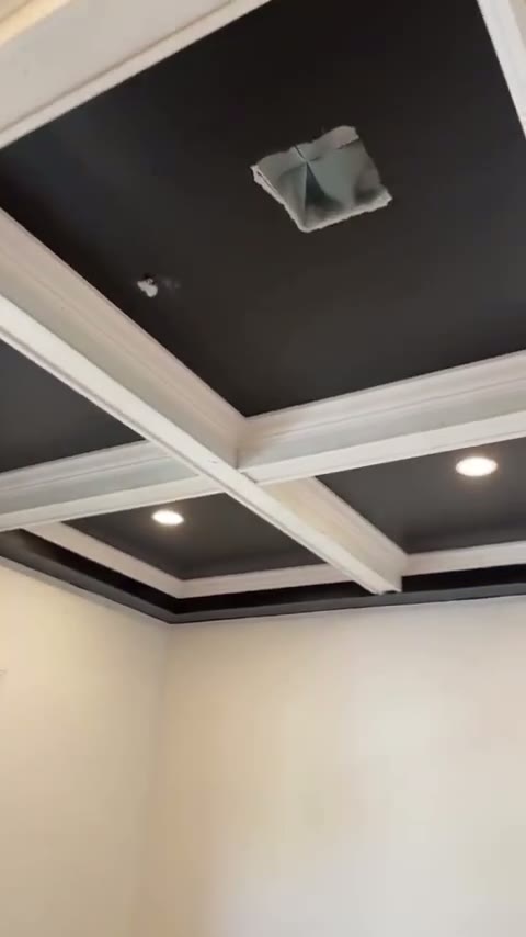 Process footage of the coffered ceiling beams and trim being installed